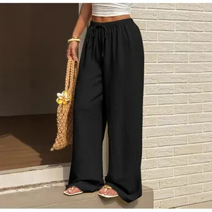 Pantalon large noir à taille haute avec cordon de serrage et tissu texturé respirant.
