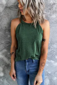Lifestyle shot of woman in dark green halter neck tank top against grey wall