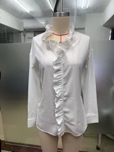 Close-up of white cotton linen top with ruffled wood ear trim detail