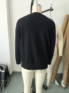 Back view of women's black loose-fit retro solid color round neck short sweater