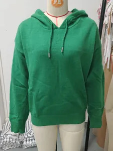 Front view of a vibrant green knitted hooded sweater on a mannequin