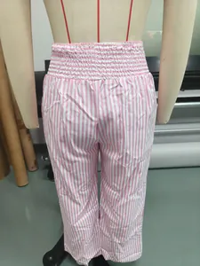 Detailed back view of pink and white vertical striped high-waisted trousers on mannequin