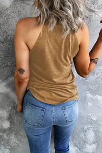Detailed back view of a minimalist camel halter neck tank top worn with blue denim jeans
