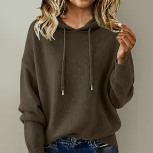 Close-up detail of a soft brown hooded knit sweater with adjustable metal-tipped drawstrings