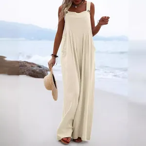 Elegant beige loose cotton linen wide leg jumpsuit for women on a summer beach