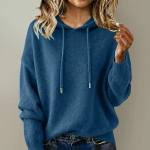 Close-up view of women's blue soft oversized knitted hoodie sweater with drawstring