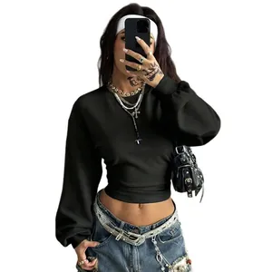 Close-up detail of a black Y2K style cropped sweatshirt featuring a slim fit and long sleeves