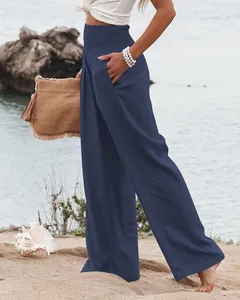 Pantalon élégant à jambes larges en coton et lin bleu marine pour femme sur la plage