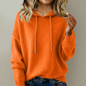 Close-up of vibrant orange knitted hooded sweater with adjustable drawstrings