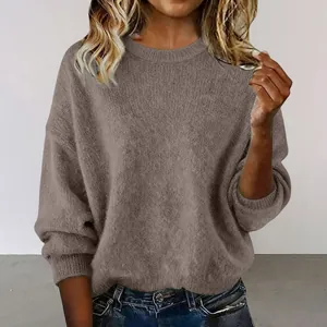 Close-up detail of a soft, loose-fit taupe knit sweater with a classic round neck.
