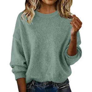 Detail of a soft sage green knit sweater showing the loose fit and soft texture.