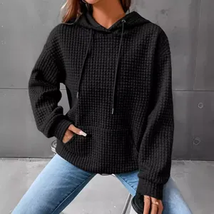 Womens casual black waffle knit hoodie sweatshirt featuring front pocket and drawstrings