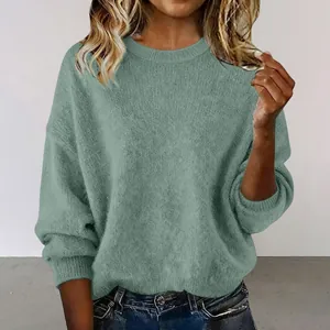Close-up showing the soft knit texture of a loose retro round neck short green sweater.