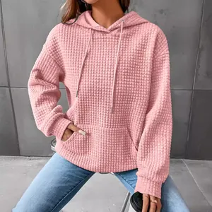 Women's stylish pink waffle-knit long sleeve hoodie with front kangaroo pocket and drawstring