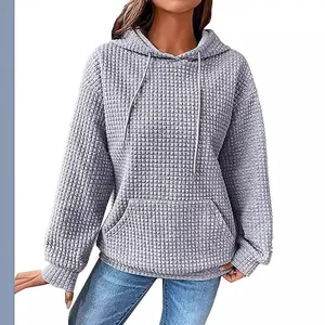 Casual women's grey waffle knit hoodie with front pocket and adjustable drawstring hood