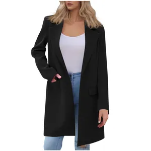 Detailed view of women's black mid-length blazer with lapel and pocket detail.