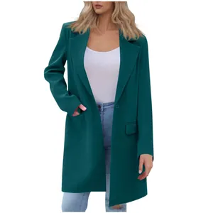 Detailed view of women's dark teal lapel coat featuring single button and pocket details