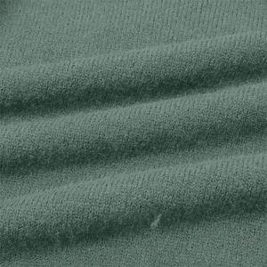 Close-up macro view of soft green knitted fabric texture showing premium fiber quality