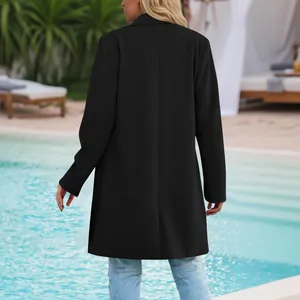 Rear view of elegant black mid-length blazer for women in resort outdoor setting