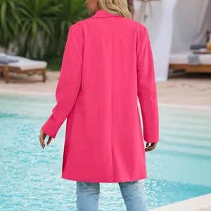 Back view of a vibrant hot pink mid-length blazer coat for women in outdoor resort setting