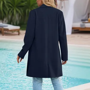 Rear view of a navy blue women's mid-length casual lapel coat at a luxury resort