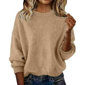 Close-up of soft khaki oversized knit sweater texture and crew neckline details.