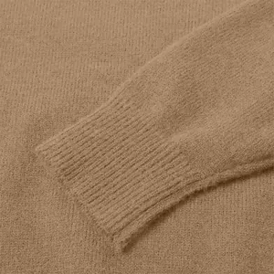 Detailed macro view of the soft ribbed cuff texture on a vintage camel knit sweater for women