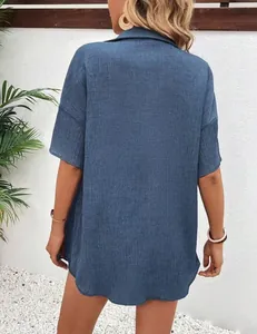 Back view of a casual loose blue short-sleeved textured shirt for women