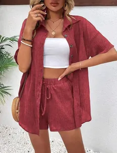 Elegant burgundy two-piece set featuring textured button-up shirt and drawstring shorts.