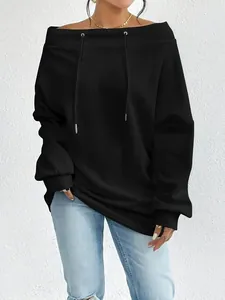 Detail showing the off-shoulder boat neck and drawstring design of black sweatshirt