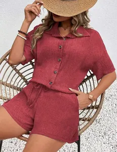 Close-up of red short-sleeve button-up shirt and shorts set with textured fabric