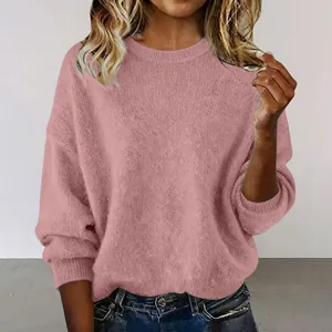 Close-up detail of soft dusty pink knit sweater featuring a loose fit and crew neck design