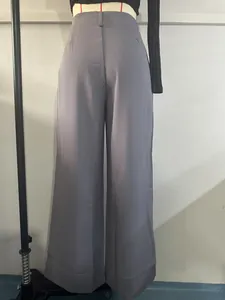 Back view of high-waisted grey suit pants on a mannequin showing straight leg fit