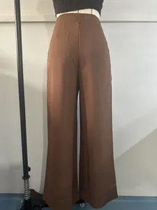 Back view of brown high-waisted wide-leg trousers displayed on a dress form.