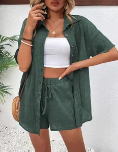Detail of women's casual green linen set featuring short sleeve shirt and drawstring shorts