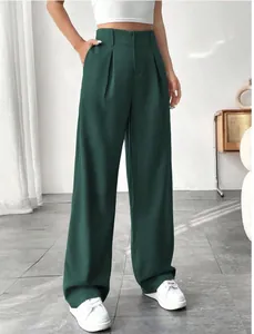Detailed view of elegant dark green high-waisted straight-leg suit trousers for women.