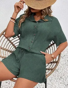 Detail view of dark green two-piece lounge set featuring a button-down shirt and shorts