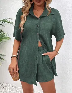 Detailed view of a dark green textured button-down shirt and matching shorts summer outfit