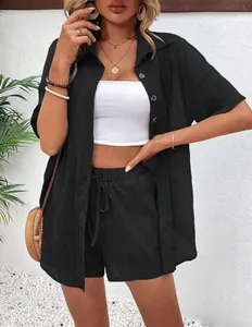 Detailed view of a black button-down linen shirt and matching drawstring shorts set