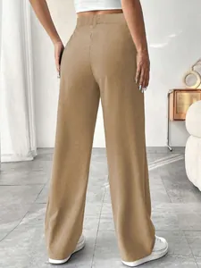 Detailed back view of elegant high-waisted straight trousers in chic camel brown.