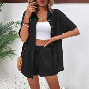 Women's two-piece black linen set with loose button-up shirt and drawstring shorts