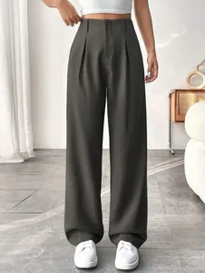 Close-up detail of elegant high-waist straight-leg suit trousers in comfortable dark grey fabric