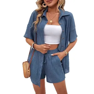 Women's chic solid blue casual set with button-down shirt and drawstring shorts.