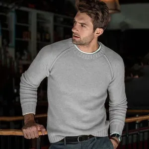 Detailed view of casual men's grey knitted sweater featuring stylish raglan sleeves
