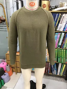 Detail view of men's olive green raglan sleeve knitted sweater on mannequin display