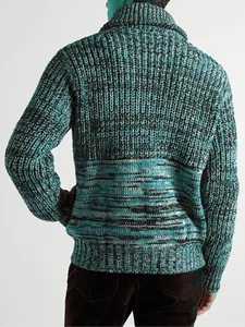 Detailed back view of a men's loose chunky knit sweater in teal and black patterned wool