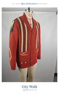 Close-up view of a men's vintage rust red shawl collar striped knit cardigan sweater.