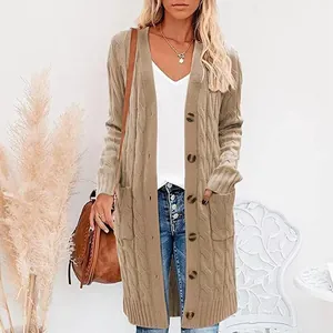 Detailed view of women's long cable-knit cardigan with buttons and front pockets