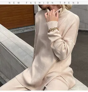 Close-up of women's beige oversized turtleneck knit sweater and pants set