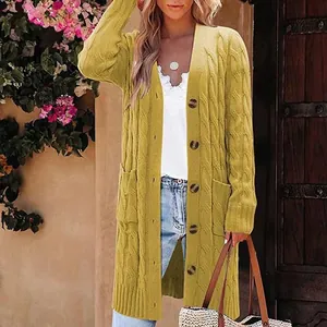 Detail view of mustard yellow cable knit long cardigan with large pockets and buttons